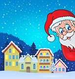 Winter village with lurking Santa Claus