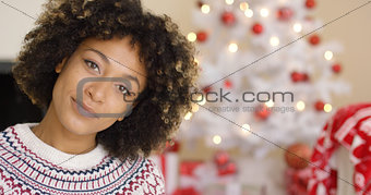 Close up on grinning woman near Christmas tree