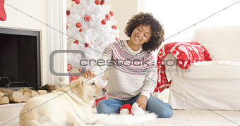 Pretty young woman stroking her dog