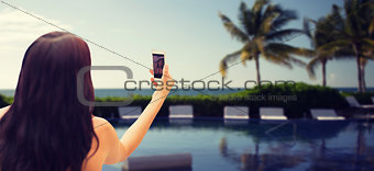 young woman taking selfie with smartphone