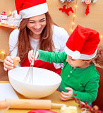 Mother with son baking Christmas cookies