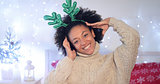 Playful young woman wearing green reindeer antlers