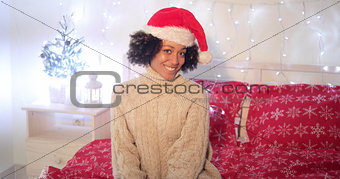 Pretty young woman wearing a red Santa hat