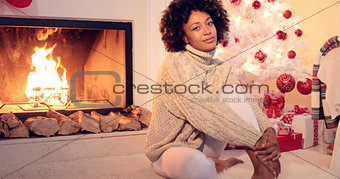 Beautiful black woman seated beside white tree