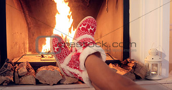 Young woman relaxing in Christmas booties