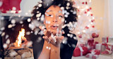 Young woman blowing confetti off her hands