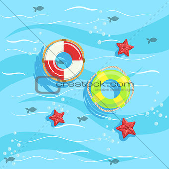 Two Ring Buoys With Blue Sea Water On Background