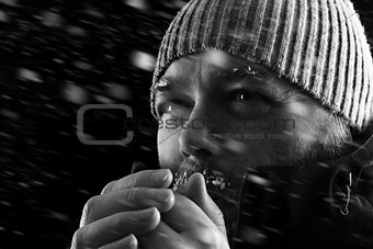 Man freezing in snow storm BW