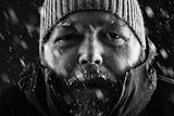Man freezing in snow storm close up