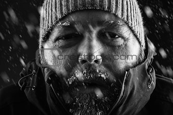 Man freezing in snow storm close up