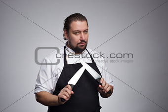 Cook holding a sharp knife.