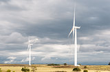 Wind turbines against dark clouds