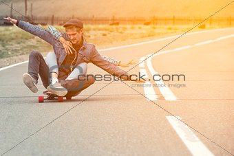 The guy with the girl drive to longboard on a mountain road. Woman hugging man. Their hands separated in different directions.