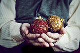 old man with christmas balls in his hands