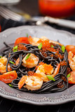 Black spaghetti with shrimps and red caviar