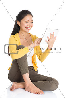 Young Asian woman using tablet pc