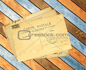 Retro post cards on ancient wooden planks