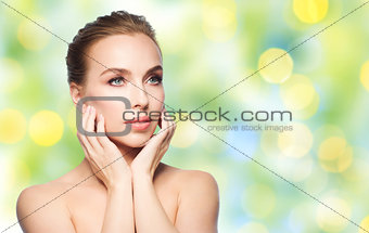 beautiful young woman touching her face