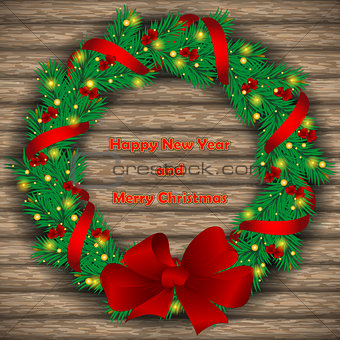 Christmas wreath with baubles and treeon background of boards.