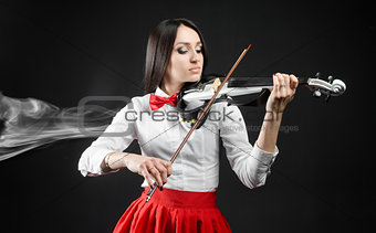Attractiv ewoman playing the violin on a black background
