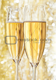 Two glasses of champagne on bokeh background