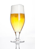 Glass of beer cider with foam golden color white