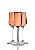 Glass of pink rose champagne with bubbles on white