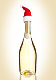 Bottle of yellow champagne with santa hat 