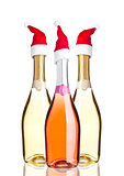 Bottles of pink yellow champagne with santa hat 