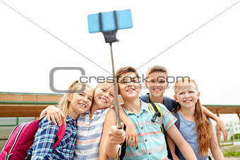 happy elementary school students taking selfie