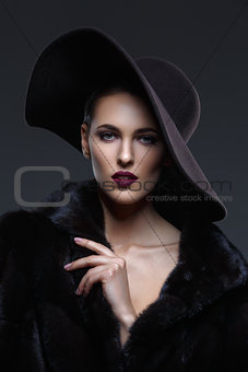 Beautiful girl in fur coat and hat