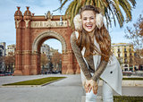 happy elegant woman in earmuffs in Barcelona, Spain standing