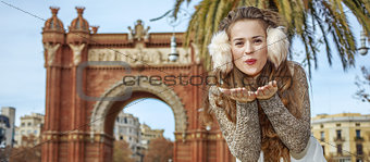 smiling fashion-monger in Barcelona, Spain blowing air kiss