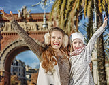 happy modern mother and child in Barcelona, Spain rejoicing