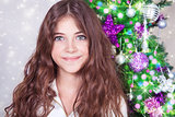Beautiful girl near Christmas tree