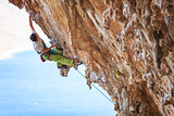 Male rock climber on a face of a cliff