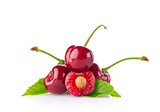 Ripe juicy cherry with green leaf.