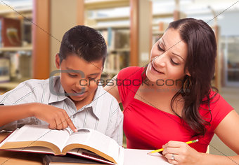 Hispanic Mother and Son Studying In Library