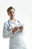 doctor looking to you and waiting holding a digital tablet