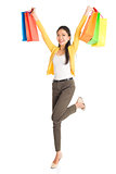Happy Asian female with shopping bags