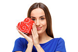 Beautiful woman holding heart shaped gift