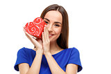 Beautiful woman holding heart shaped gift