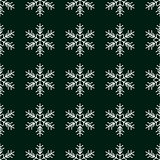 Seamless pattern with snowflakes on green