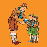 scoutmaster shows little insect to young scouts