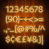 Glowing Neon Numbers on Wooden Background