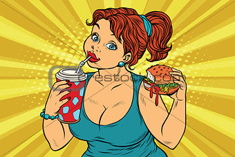 Young woman drinking Cola and eating Burger