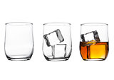 Glasses with whiskey and ice cubes and empty glass