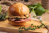 Trendy glossy breakfast burger with ham and eggs