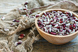 Speckled beans in a wooden bowl.