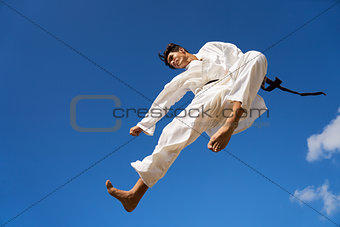 Extreme Sport Hispanic Athlete Jumping During Karate Fight